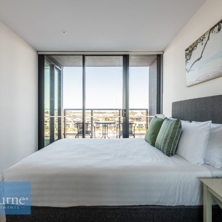 side angle of second bedroom with floor to ceiling glass doors